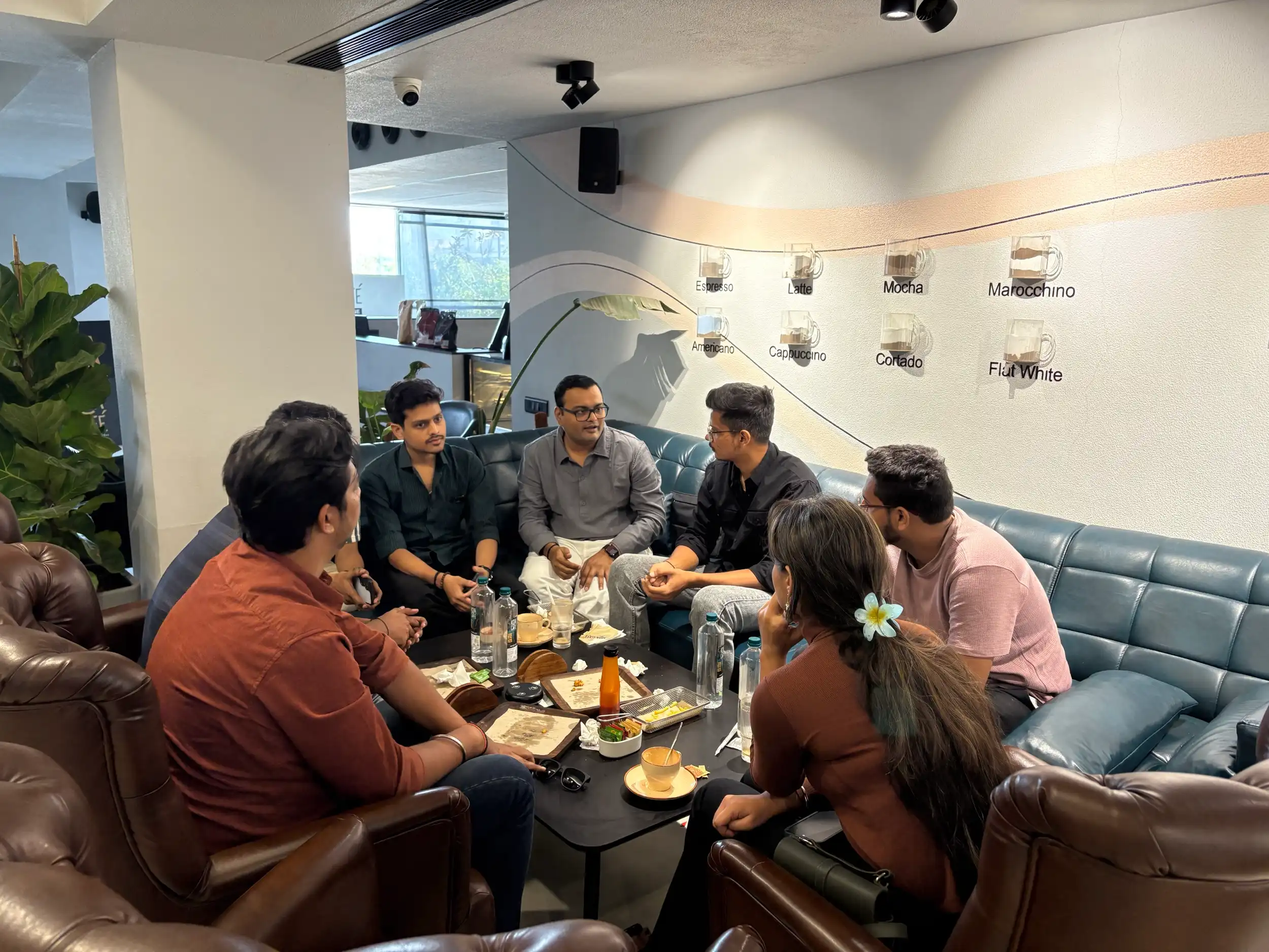 Vadodara Design Community members talking on the couches at a café meet-up