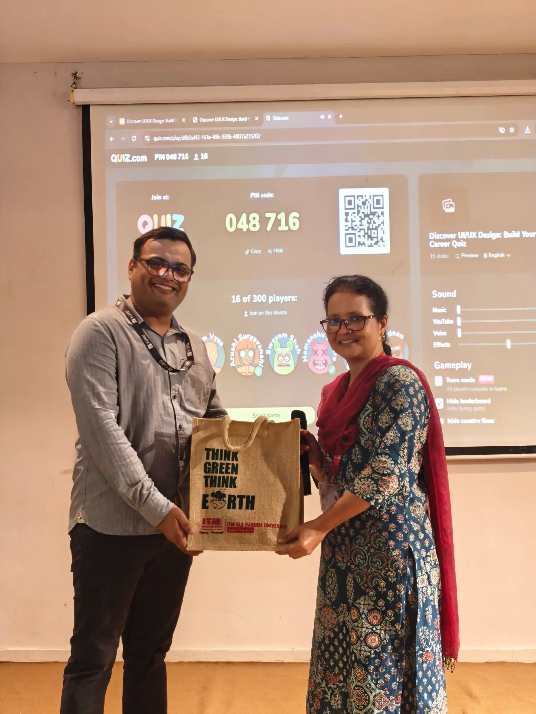 Handing over a prize at a design quiz session
