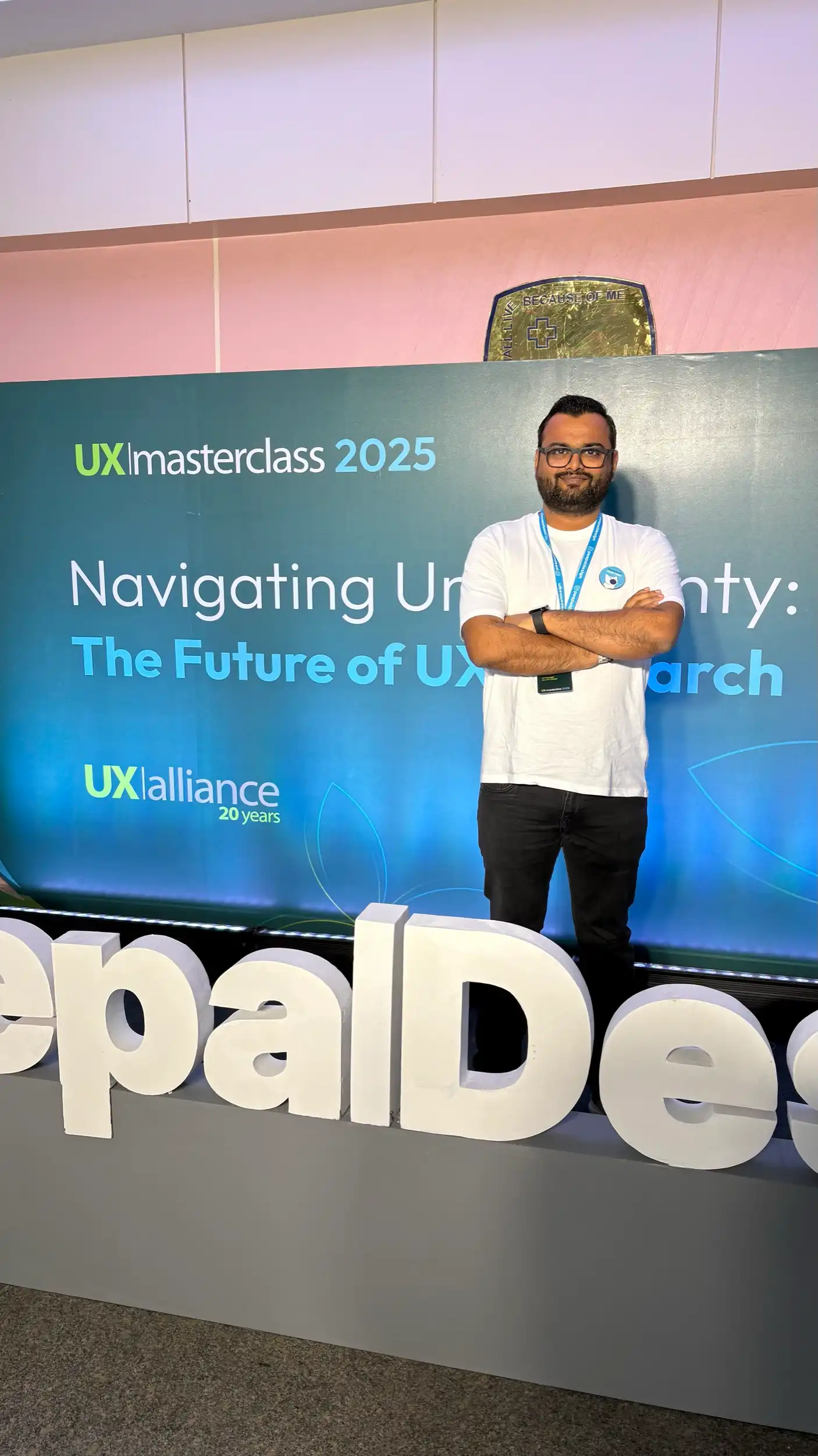 Standing in front of the UX Masterclass 2025 sign